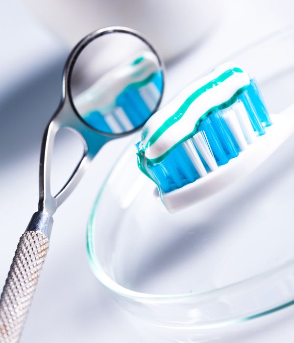 Photo of a toothbrush and a dental mirror